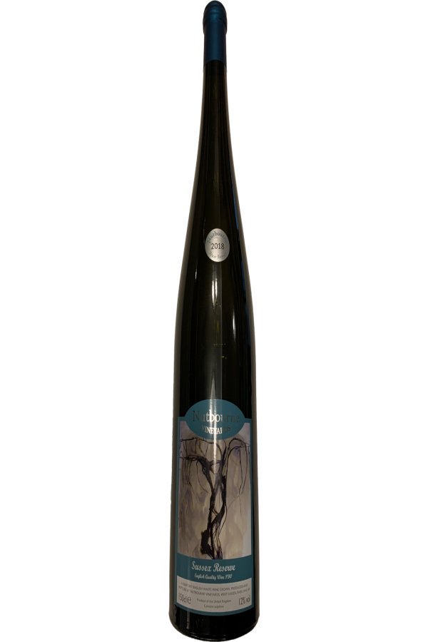 A dark bottle of wine from Sussex reserve. There is a dark green label on the bottle, with a tree on.