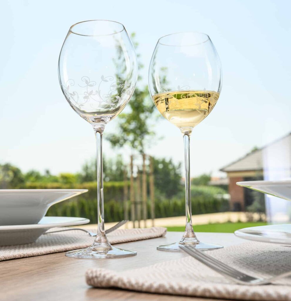 English white wine in a glass on a table in the summer sunshine