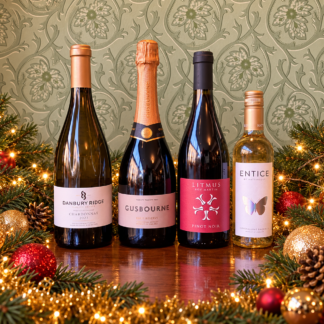 Four bottles of English wine in a Christmas setting